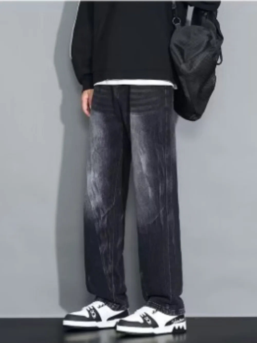 Men's dark wash loose-fit jeans with a faded effect.