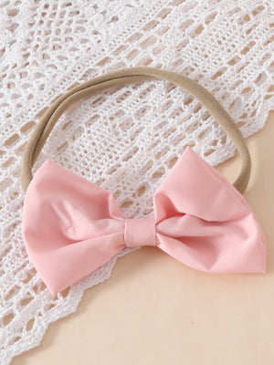 Pink bow headband with lace trim detail