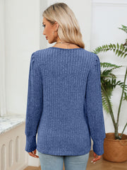 Cobalt blue ribbed knit sweater with puff sleeves and crochet trim detail.