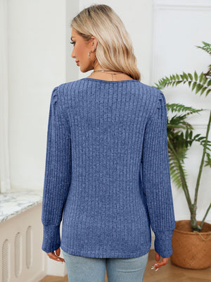 Cobalt blue ribbed knit sweater with puff sleeves and crochet trim detail.