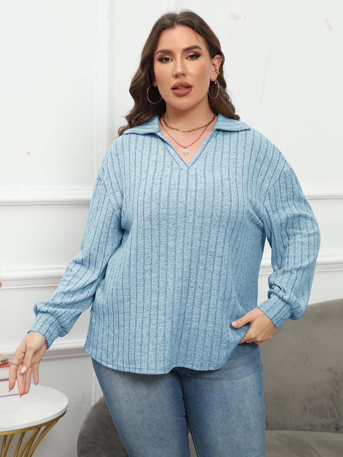 Relaxed ribbed polo top in pastel blue with a V-neck and long sleeves.