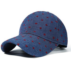 Blue denim baseball cap with all-over red heart pattern