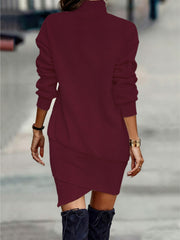 Burgundy turtleneck mini dress with asymmetrical hem and long sleeves.