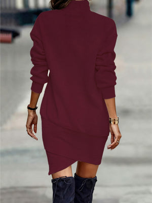 Burgundy turtleneck mini dress with asymmetrical hem and long sleeves.