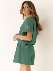 Textured gauze co-ord set in dark green with ruffle sleeves and shorts.