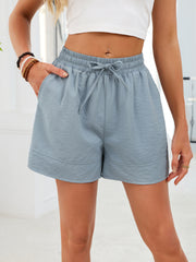 Blue jogger shorts with drawstring waist and pockets.