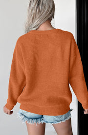 Terracotta knit sweater with ribbed texture and crew neck.