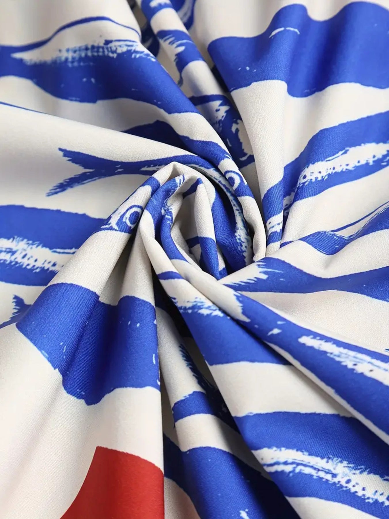 Sardine graphic spaghetti strap midi dress in royal blue and white with a bold brushstroke pattern.