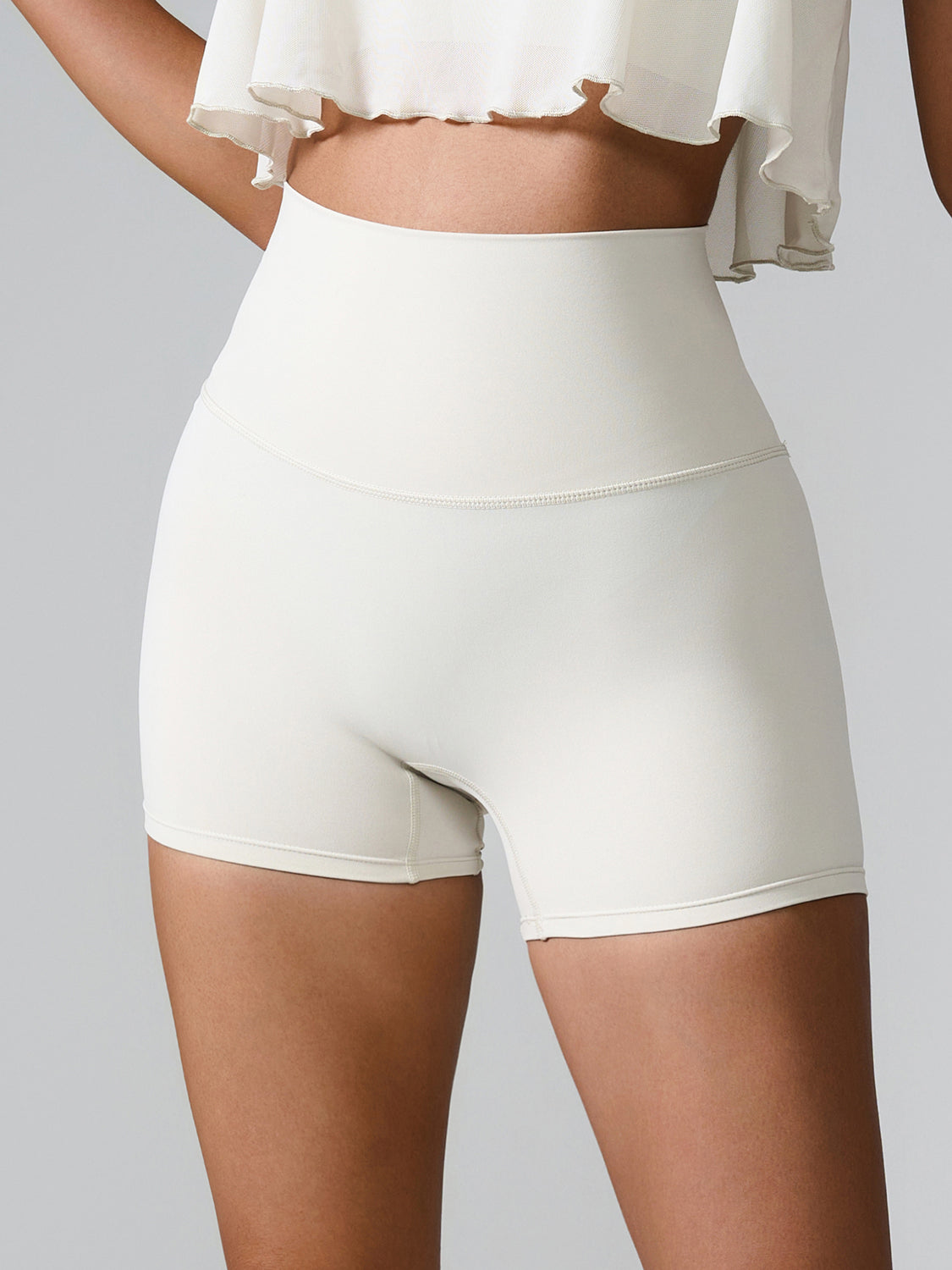 White active shorts with high waist and sculpted detail, perfect for workouts.