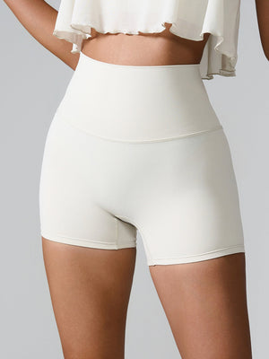 White active shorts with high waist and sculpted detail, perfect for workouts.