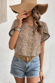 Leopard print blouse with pom-trim flutter sleeves and a round neckline.
