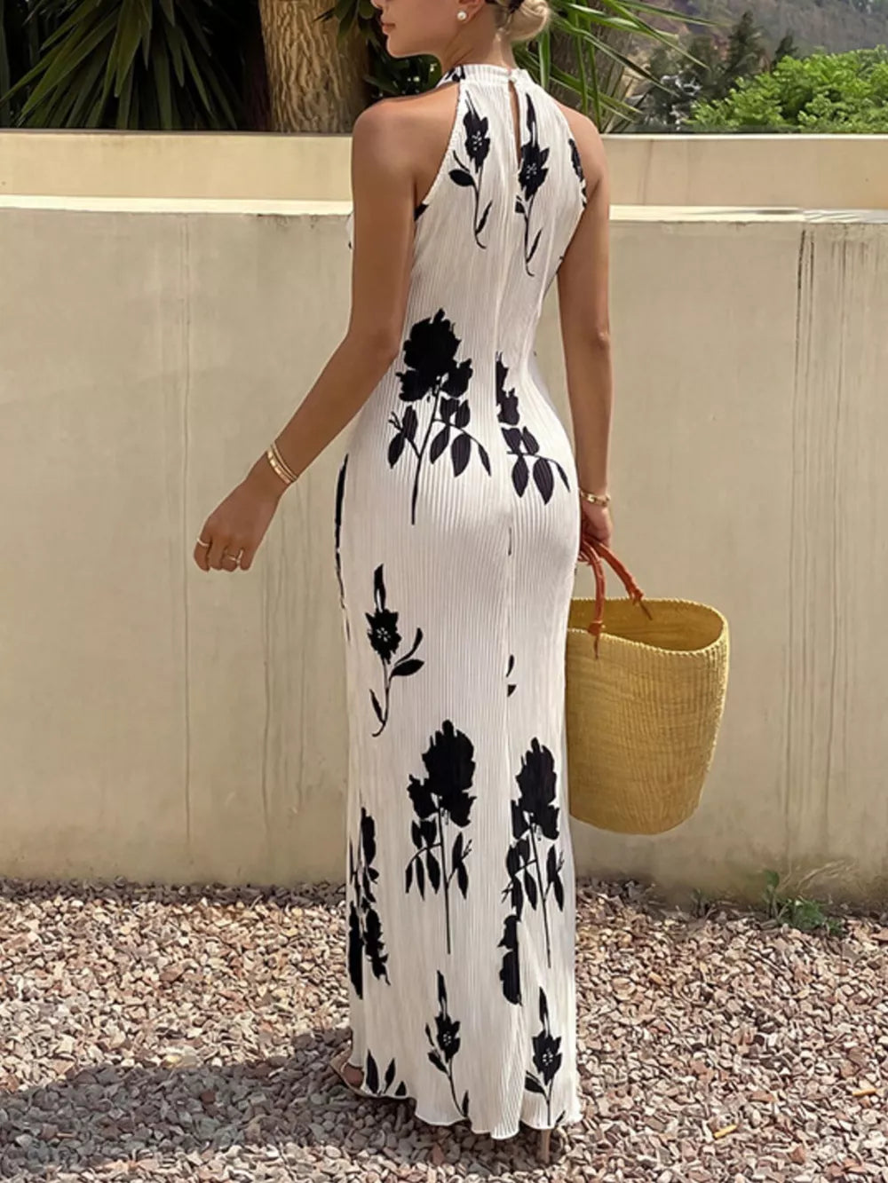 White floral print halter maxi dress with pleated fabric and a-line cut.
