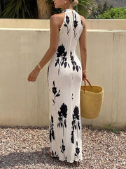 White floral print halter maxi dress with pleated fabric and a-line cut.