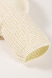 Cream knit sweater sleeve with ribbed cuff detail