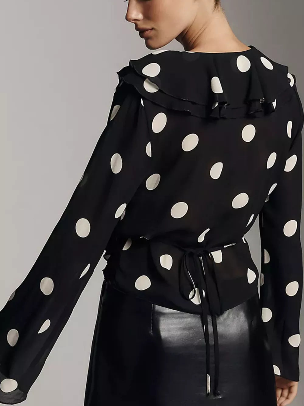 Black polka dot sheer blouse with ruffled V-neck and tie waist