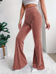 Textured corduroy bell bottom trousers in dusty pink with vertical ribbing.