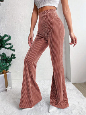 Textured corduroy bell bottom trousers in dusty pink with vertical ribbing.