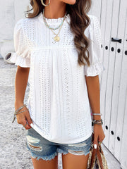 White eyelet blouse with ruffled puff sleeves and mock neck.