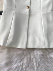 White belted two-piece set with gold button detail and pleated skirt.