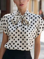 White polka dot shirt with bow tie neck and cap sleeves