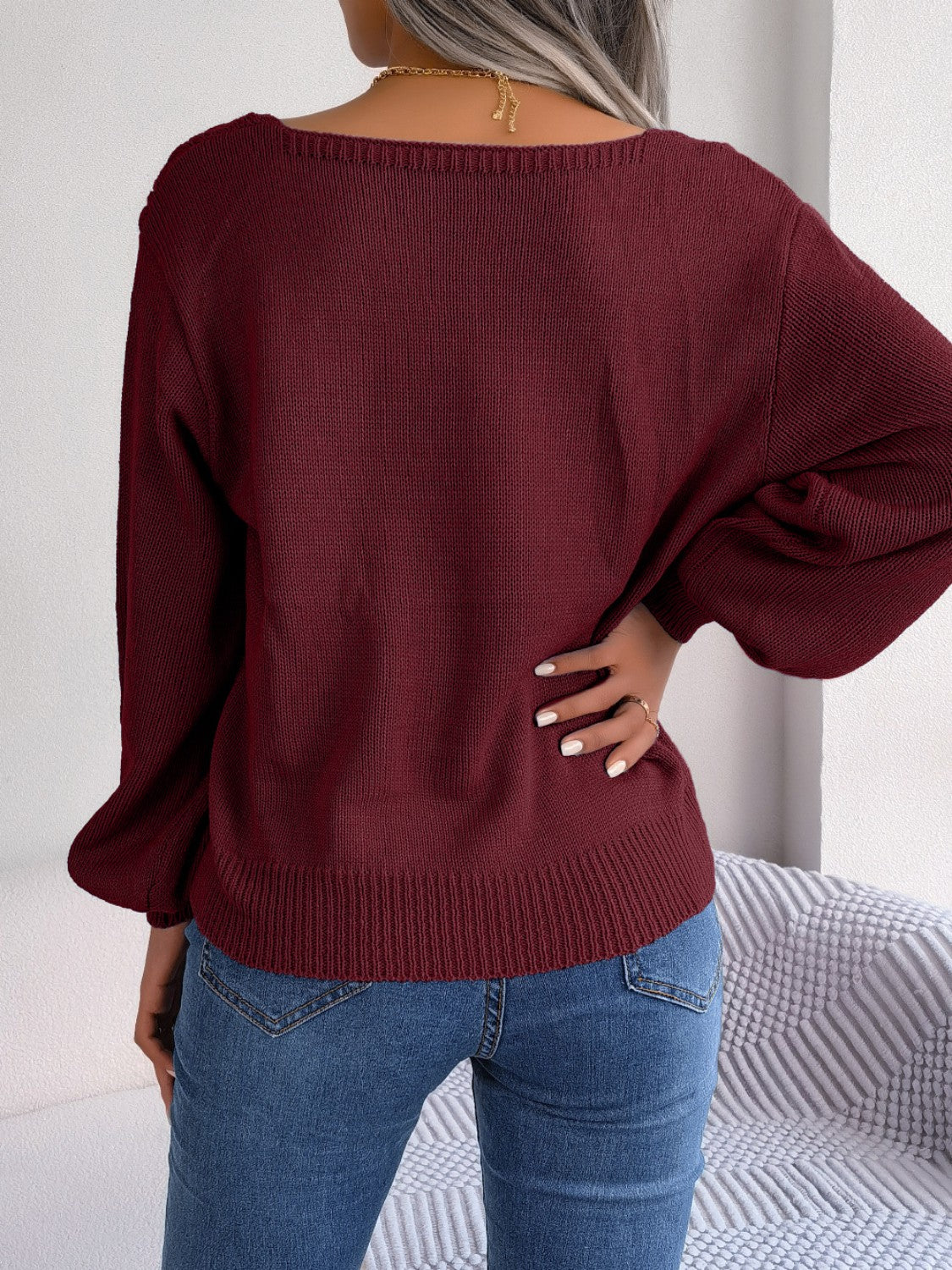 Wine cable knit acrylic sweater with square neckline and balloon sleeves.
