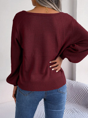 Wine cable knit acrylic sweater with square neckline and balloon sleeves.