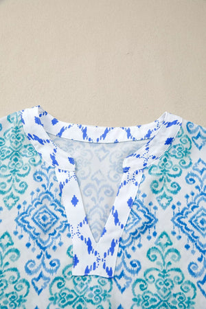Patchwork babydoll shirt with V-neck and blue/teal ikat print.
