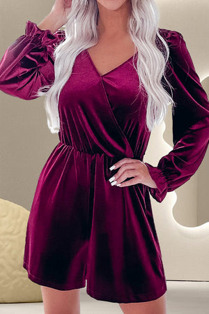 Burgundy velvet wrap romper with V-neck, cinched waist, and ruffled cuffs.