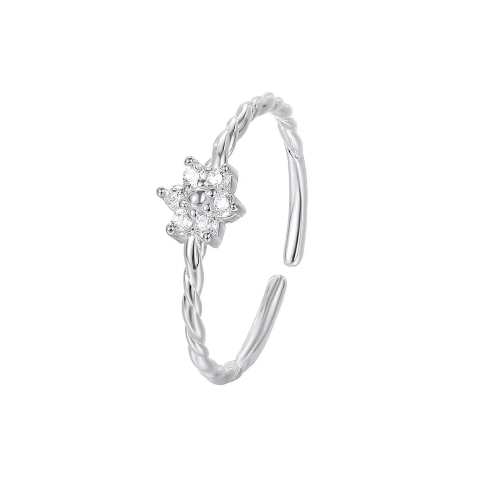 Sterling silver ring with twisted band and a delicate zircon flower detail.