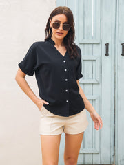 Black short sleeve buttoned blouse with a notch neckline.