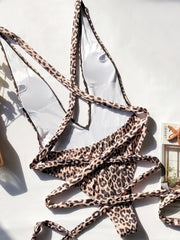 Leopard print one-piece swimsuit with wrap detail and deep V-neckline.
