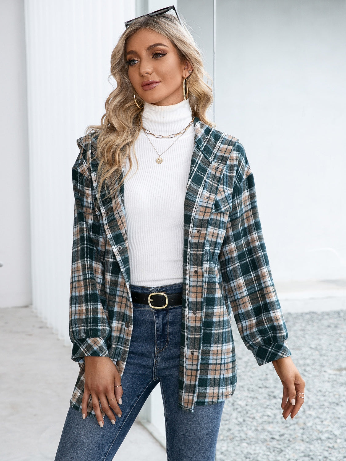 Oversized hooded shacket in deep teal plaid with snap closure and a casual, chic style.