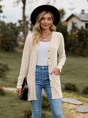 Longline ribbed knit button-down cardigan in beige with two front pockets.