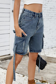 Medium blue denim cargo shorts with straps and multiple pockets.