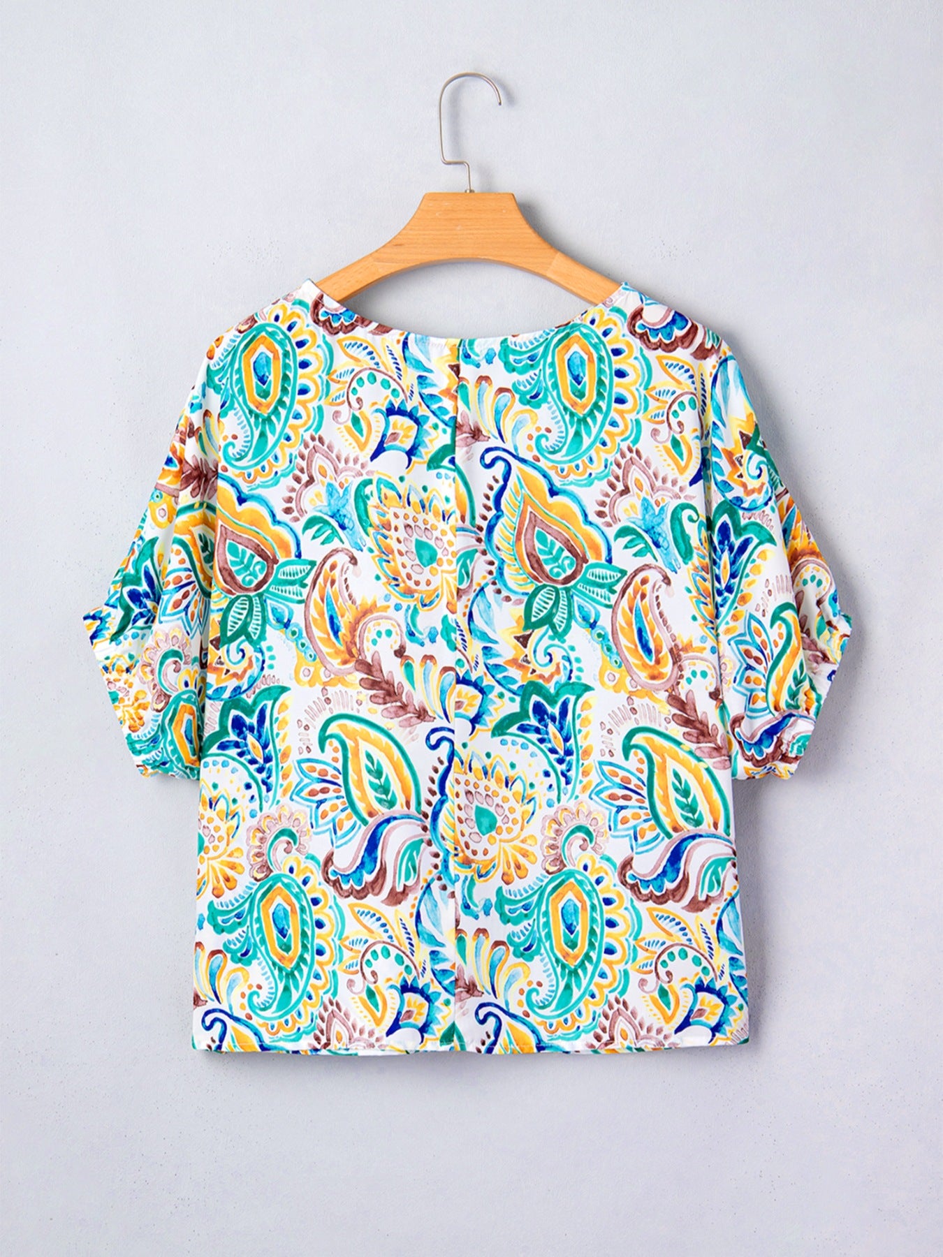 Paisley floral puff sleeve blouse with a round neckline and short sleeves.