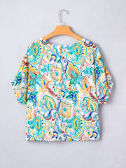 Paisley floral puff sleeve blouse with a round neckline and short sleeves.