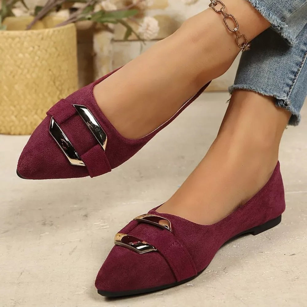 Elegant pointed-toe slip-on flats in burgundy suede with double buckle detail.