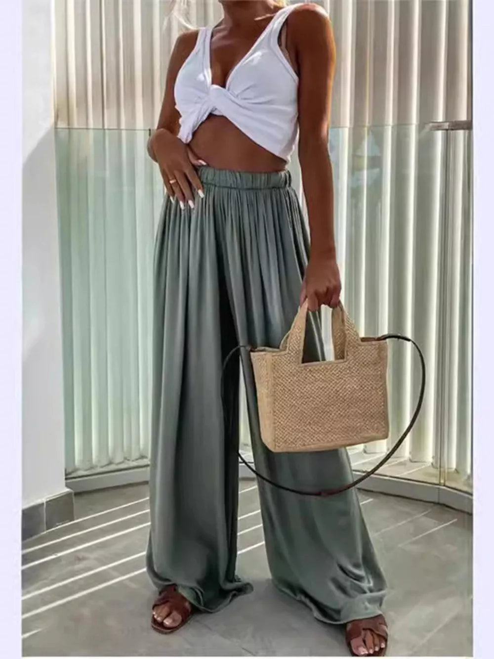 Green maternity paperbag waist pants with adjustable fit and wide legs.