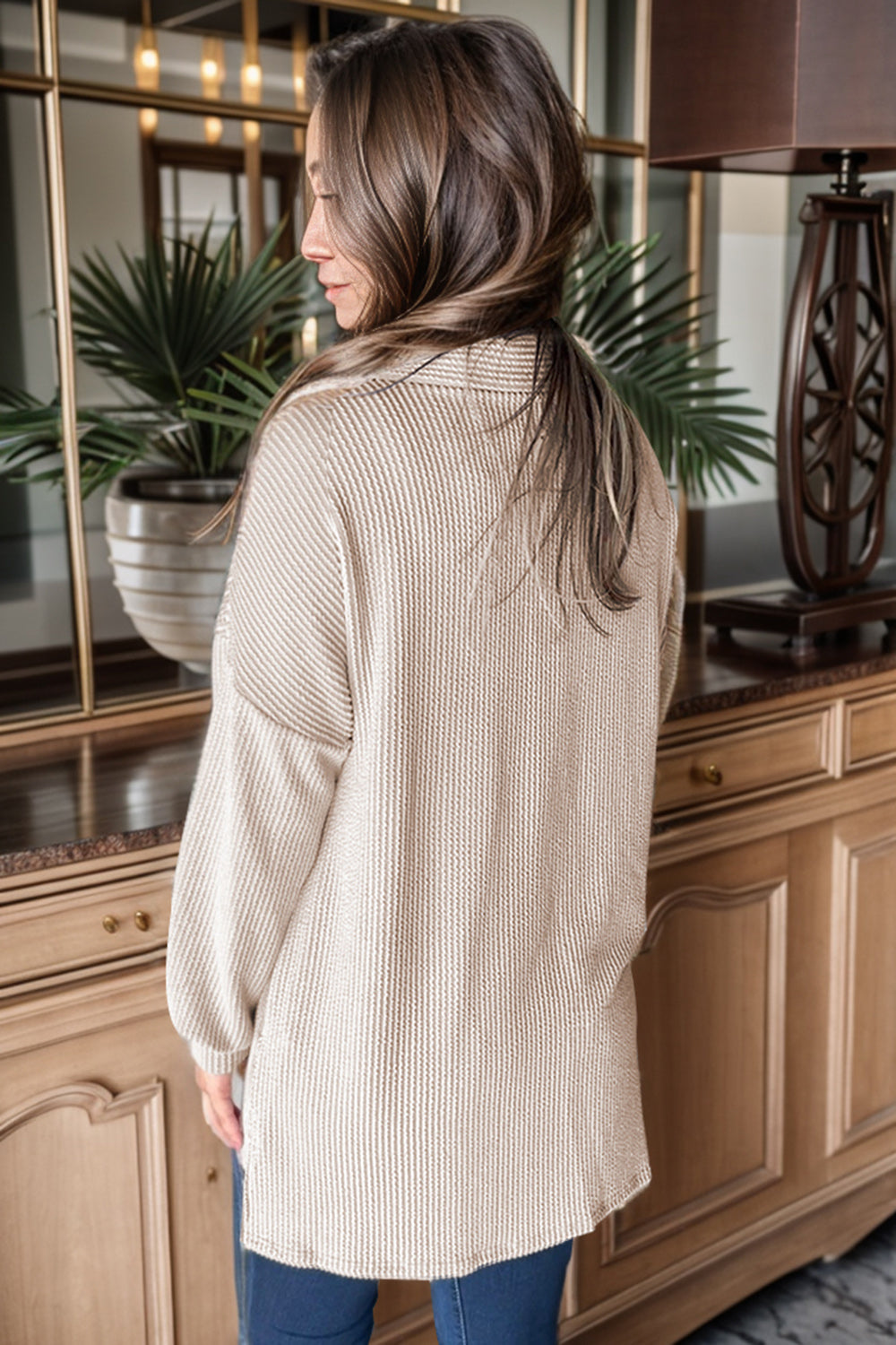 Tan textured knit shirt jacket with buttoned front and balloon sleeves.