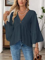 Navy blue cotton V-neck blouse with bell sleeves and a button detail.