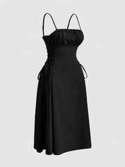 Black cami dress with ruched bodice, crisscross lace-up sides, and A-line skirt.