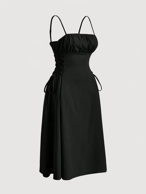 Black cami dress with ruched bodice, crisscross lace-up sides, and A-line skirt.