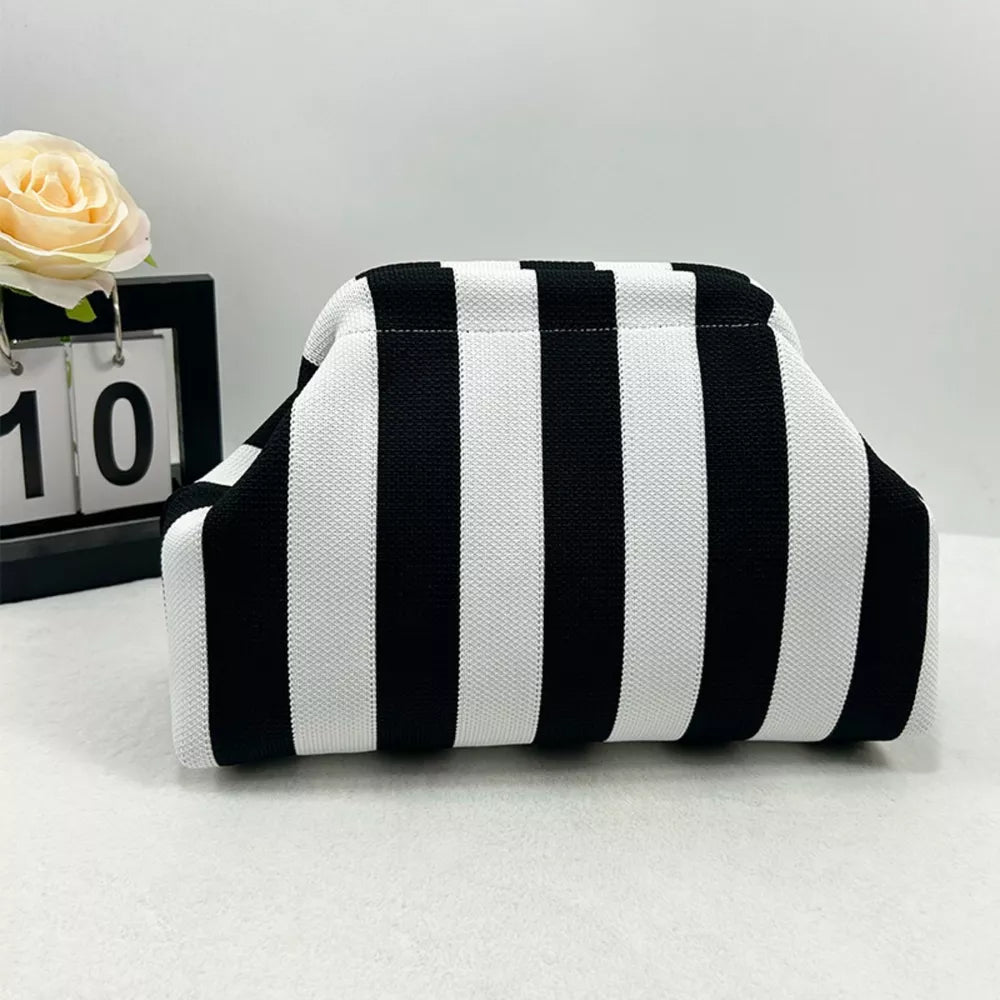 Vibrant knit clutch with striking black and white stripes