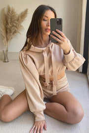 Blush pink cropped hoodie and shorts set with tie details and balloon sleeves.