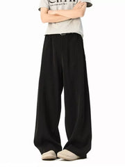 Men's black wide-leg track pants with a relaxed fit and belt detail.