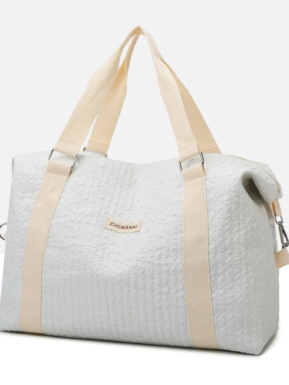 Light gray waffle-weave weekend bag with cream straps and silver hardware.