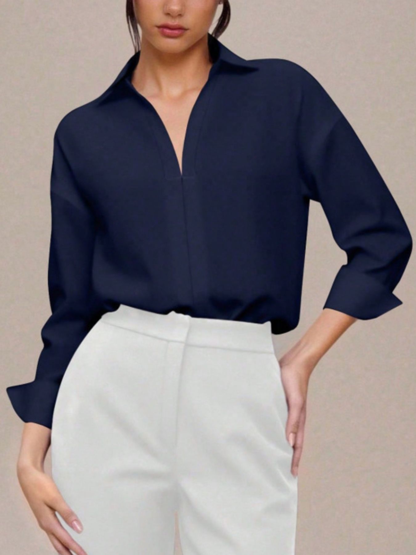 Navy blue long sleeve collared bodysuit with a deep V-neckline.
