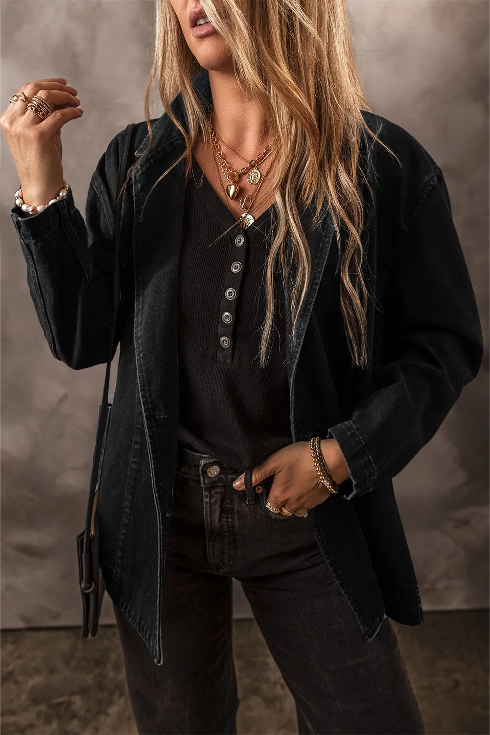 Dark denim double-breasted blazer with notched lapels and button front, worn open.