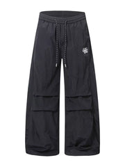Black wide-leg cargo pants with drawstring waist and large side pockets.