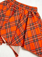 Orange plaid baby skirt with elastic waistband and flared hem.